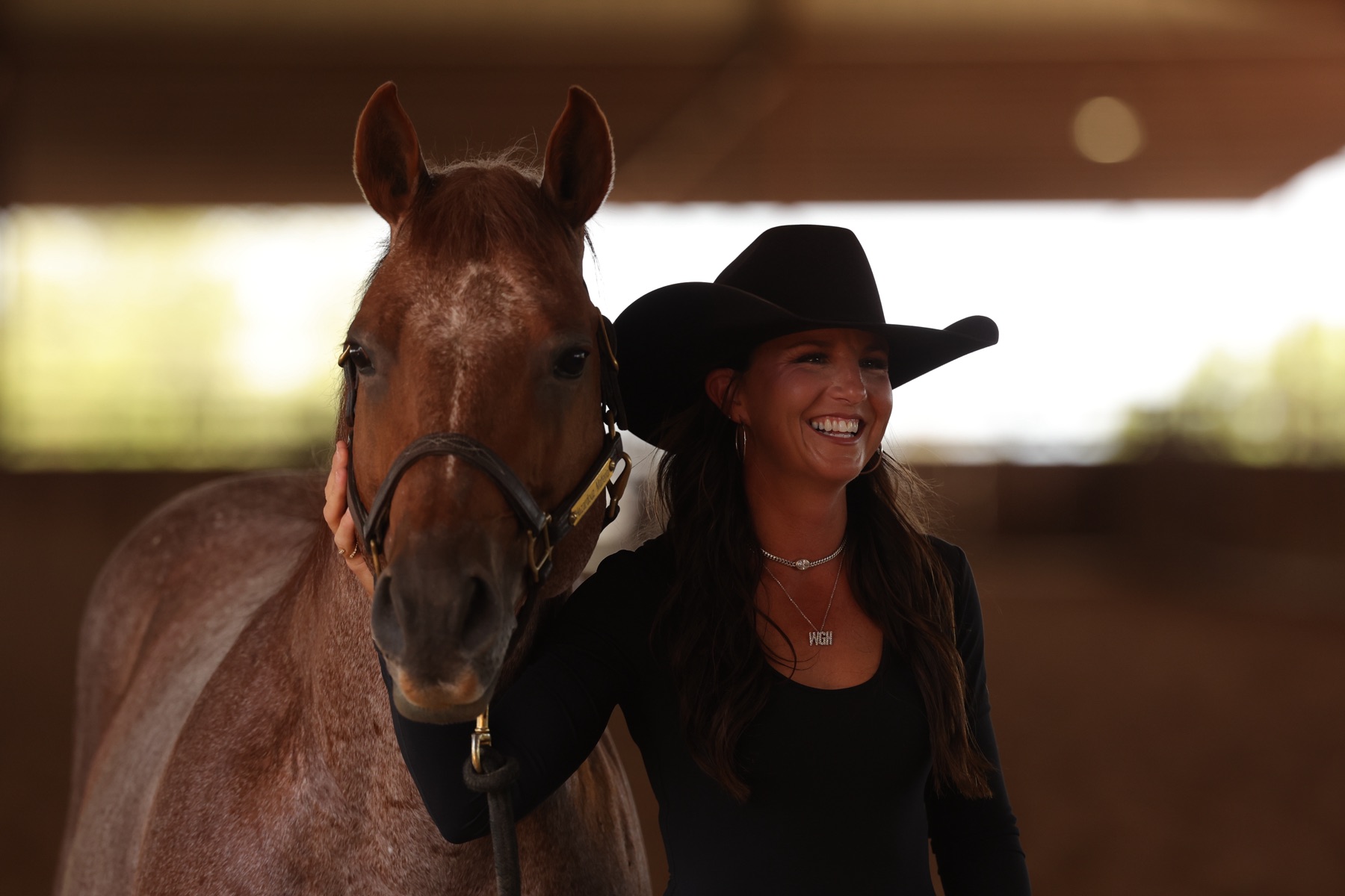 Erin Taormino smiling beside Hazardouz Material in the barn